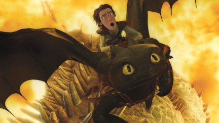 A boy rides a dragon through fire in 
