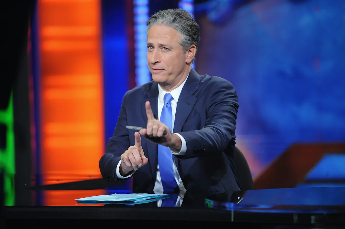 John Stewart sits at the news desk during his final episode of The Daily Show