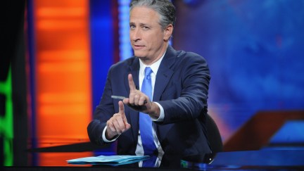 John Stewart sits at the news desk during his final episode of The Daily Show