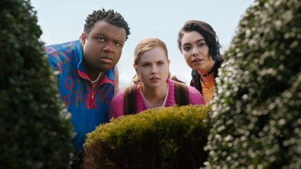 Damian, Janis, and Cady all looking through the bushes in 'Mean Girls'