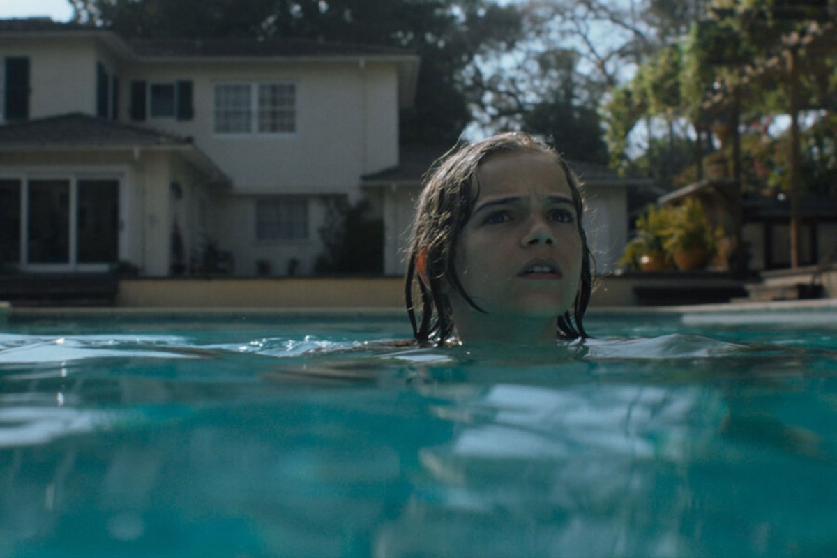 Elliot Waller (Gavin Warren), a little boy, swims in a pool in 'Night Swim'.
