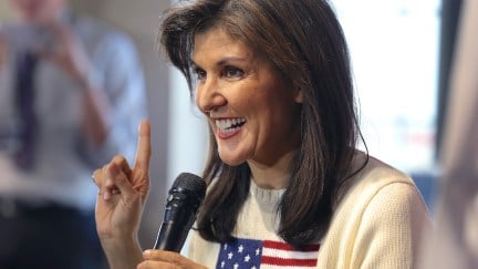 Nikki Haley smiles while speaking into a microphone
