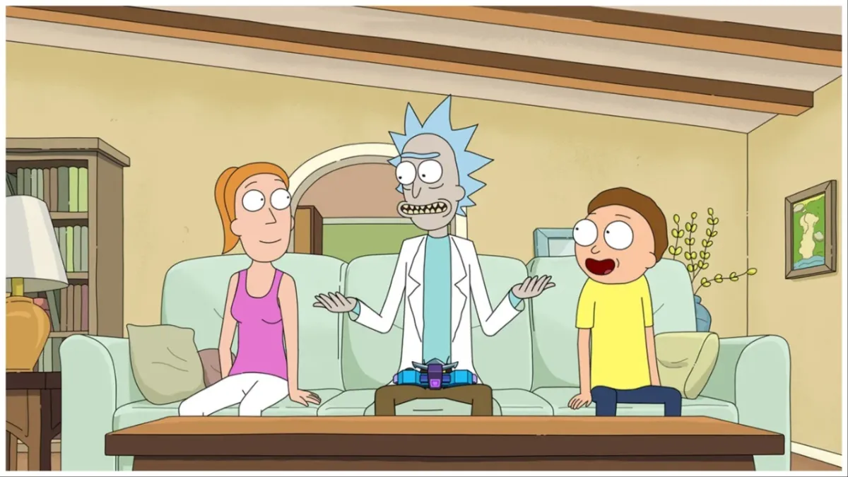 Summer, Rick, and Morty sit on the couch in 'Rick and Morty'.