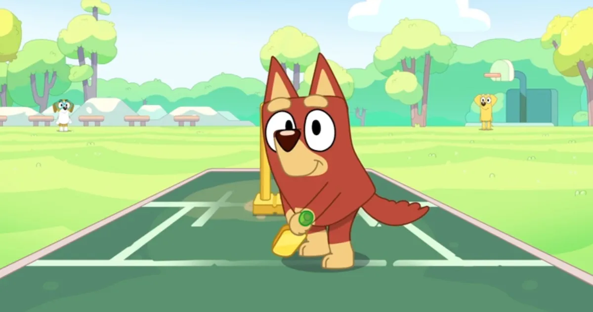 Rusty, a small red dog, plays cricket in Bluey.