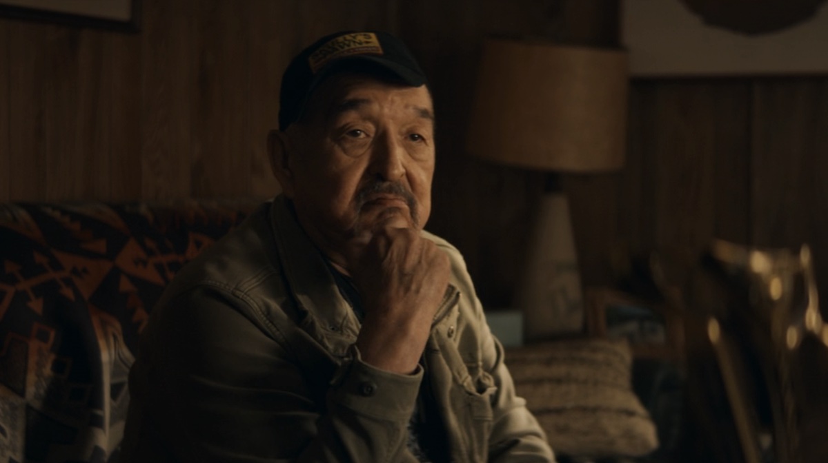 Graham Greene as Skully, sitting on Maya's couch in Echo.