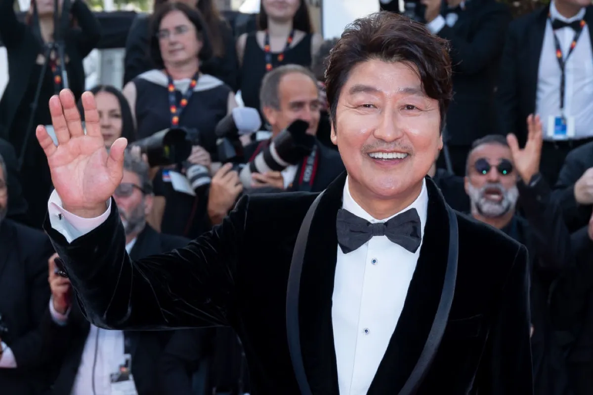 Song Kang-ho waves to the camera at Cannes.