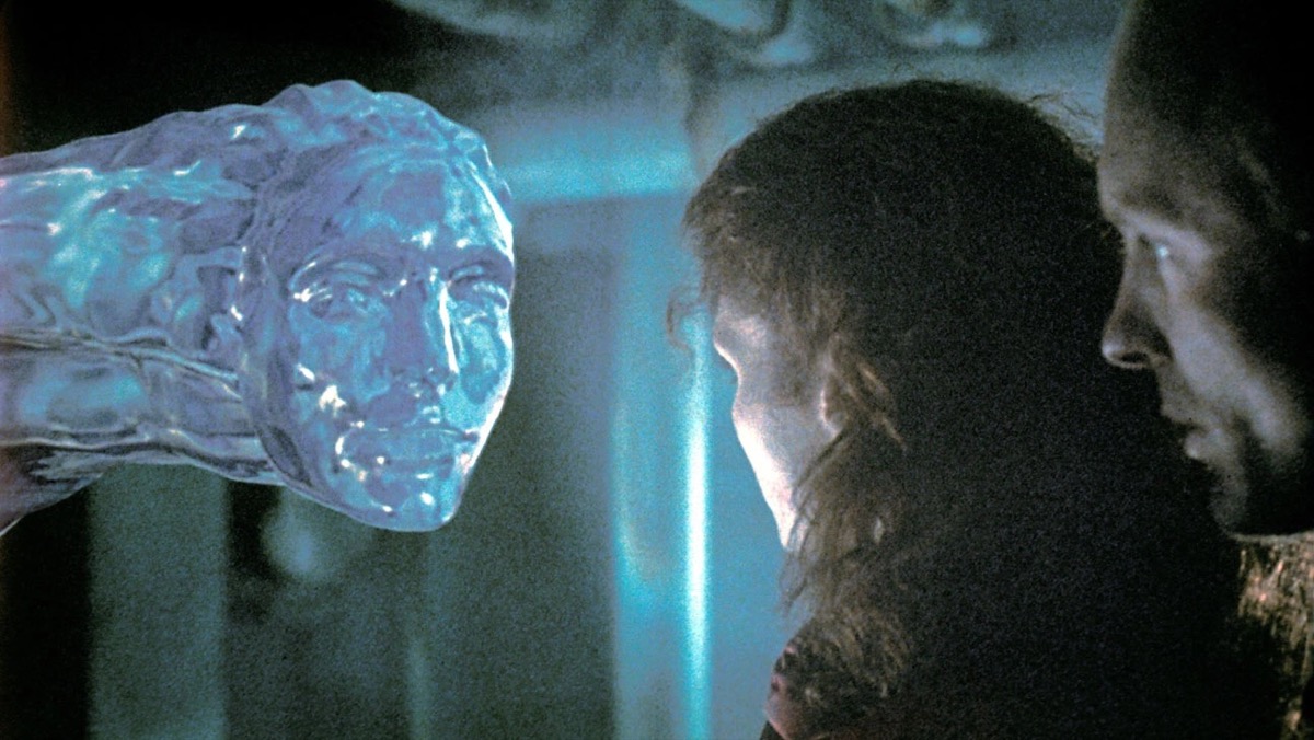 A watery alien peers into the face of a woman in "The Abyss" 
