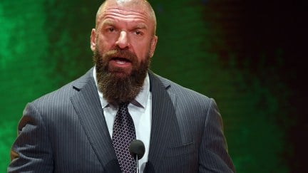 Triple H standing at a mic talking