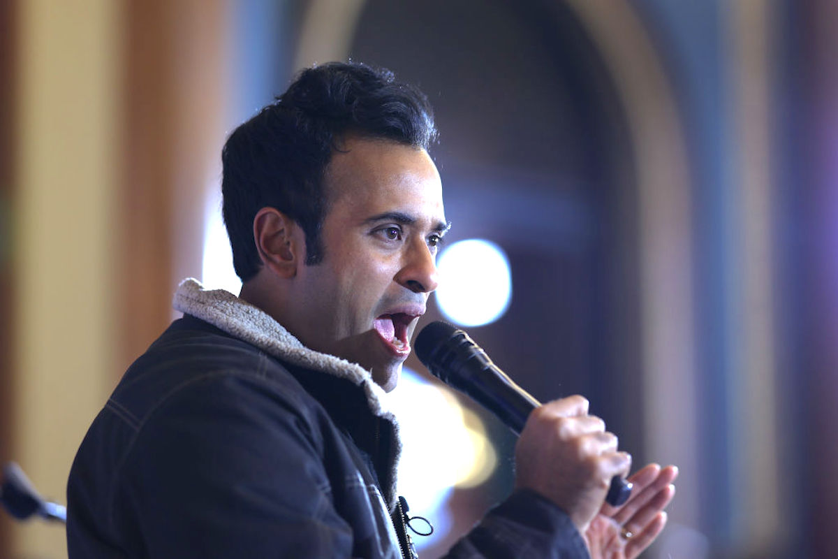 Vivek Ramaswamy yells into a microphone.