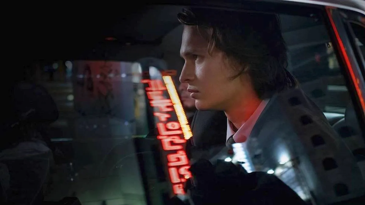 Ansel Elgort rides in the back of a car in Tokyo Vice