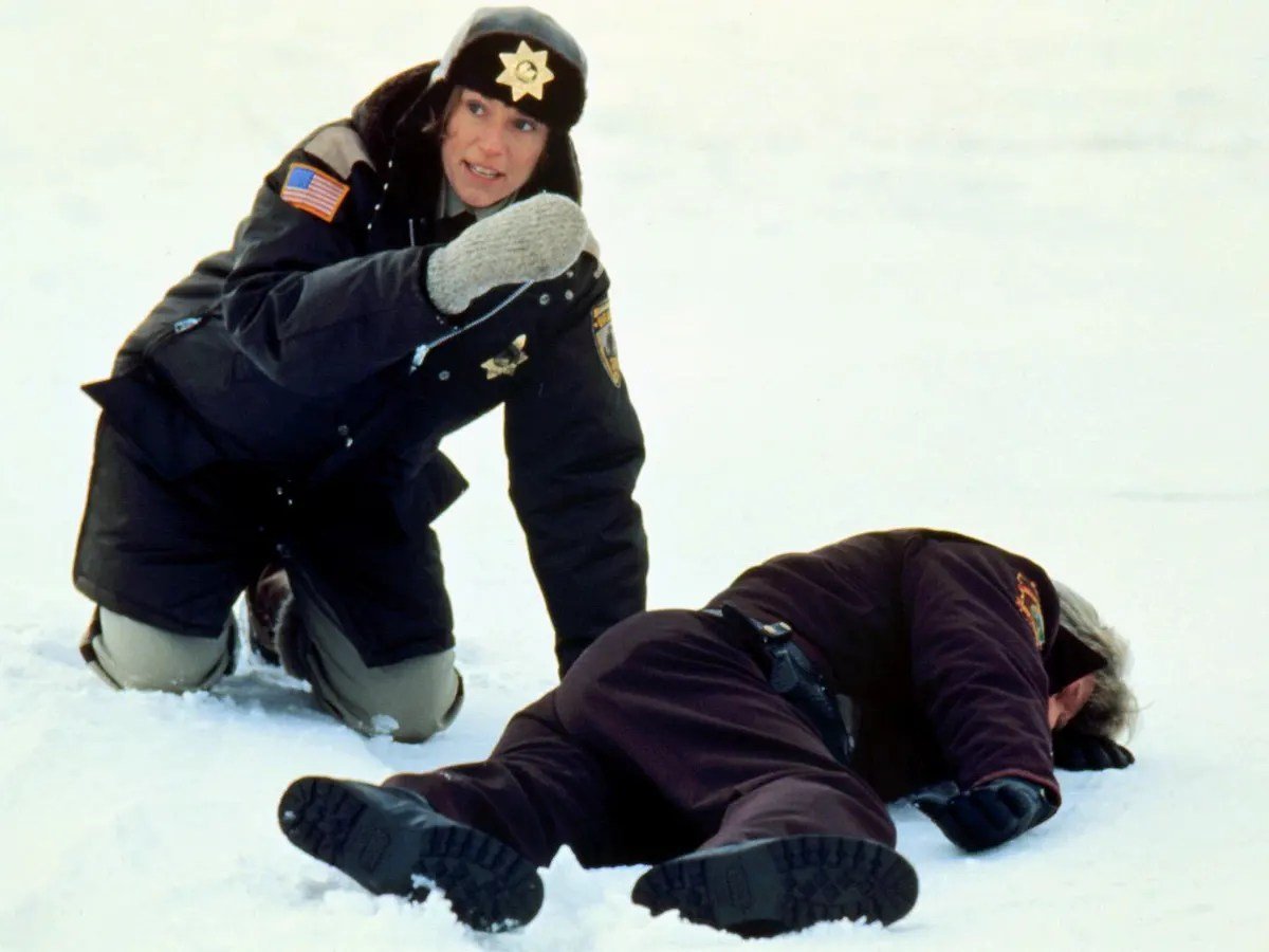 Francis McDormand as Margie bending over dead man in Fargo