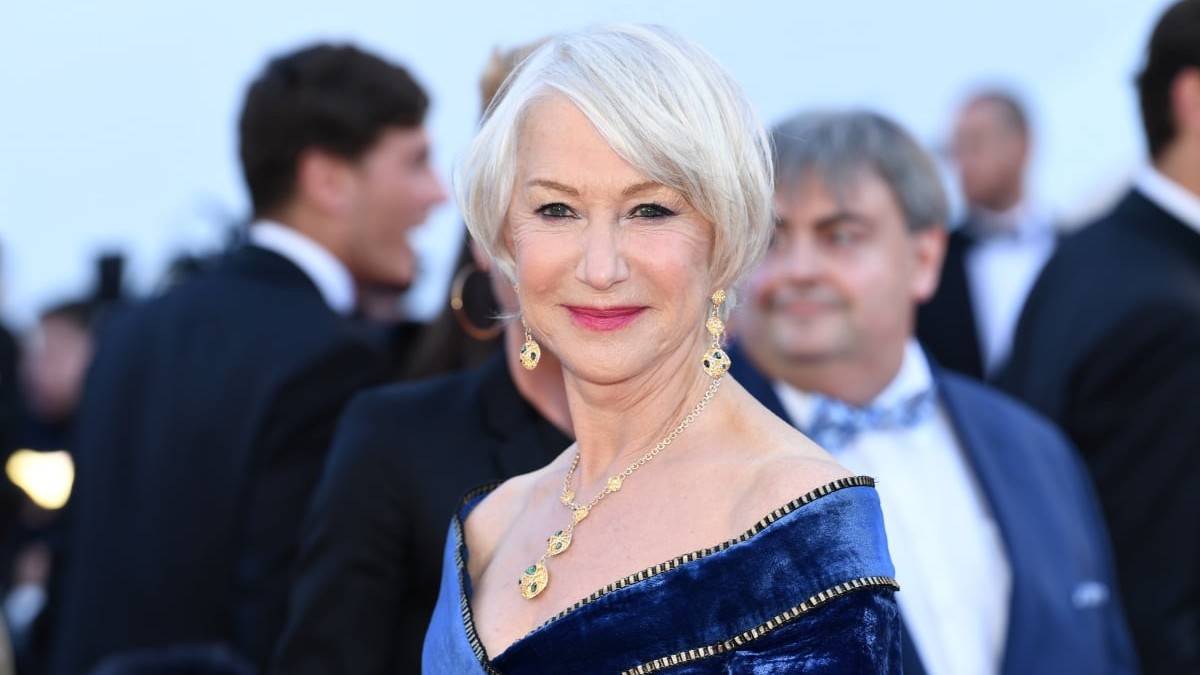 Helen Mirren wears a blue gown on the red carpet.