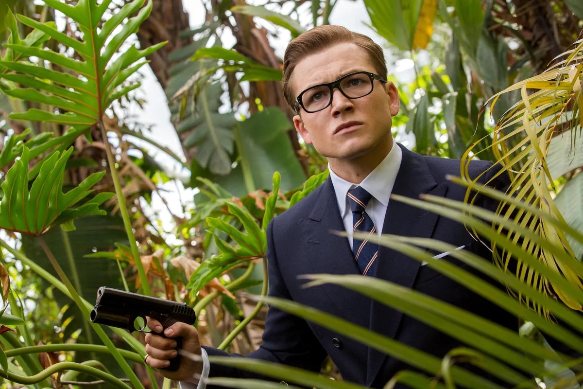 Taron Egerton as Eggsy in a jungle in Kingsman: The Golden Circle 