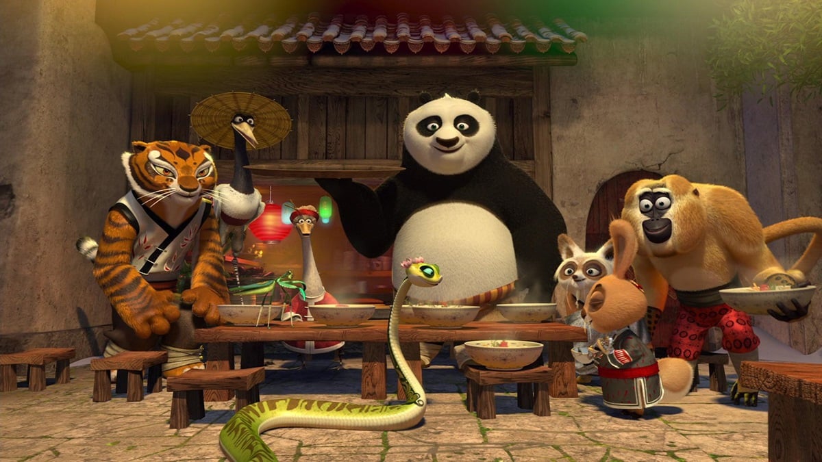 Po the panda and the furious five sit around a table in Kung Fu Panda Holiday