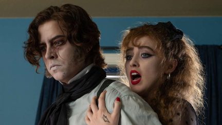 Lisa (Kathryn Newton) holds back The Creature (Cole Sprouse) in Lisa Frankenstein