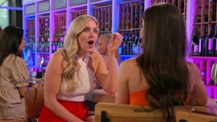 A blonde woman (Laura) has her mouth open in shock while talking to Jessica on 'Love Is Blind'.