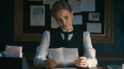 Kate Phillips as Eliza Scarlet reading a letter in 'Miss Scarlet and the Duke' season 4