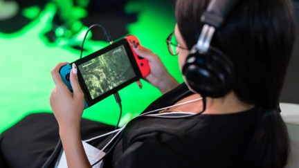 CHIBA, JAPAN - SEPTEMBER 21: An attendee plays a video game on a Nintendo Switch gaming console during the Tokyo Game Show at Makuhari Messe on September 21, 2023 in Chiba, Japan. The trade show will be held until September 24.