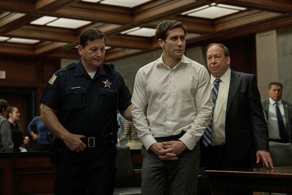 Jake Gyllenhall with handcuffs on and being brought into court in Presumed Innocent.