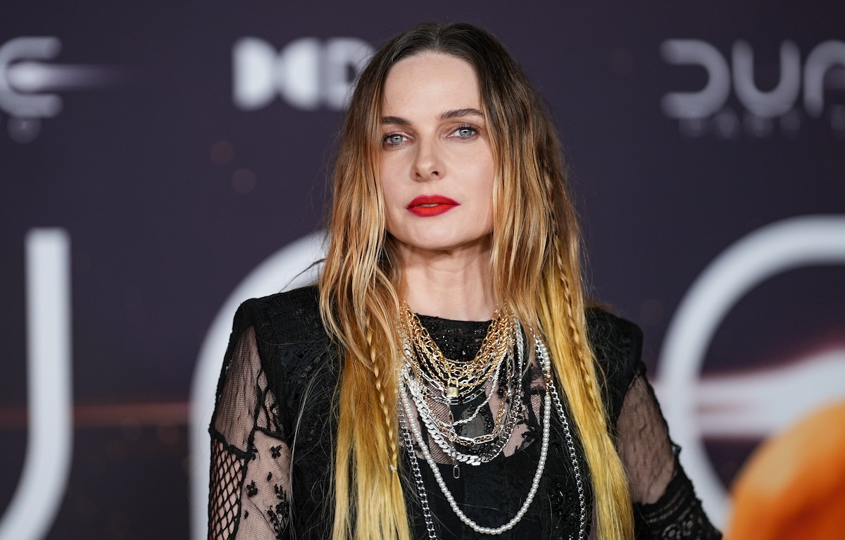 Rebecca Ferguson standing on a carpet looking great