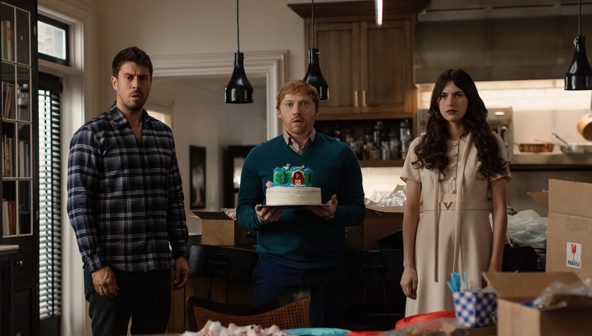 Toby Kebbell, Rupert Grint, and Nell Tiger Free stand starring at camera in Servant