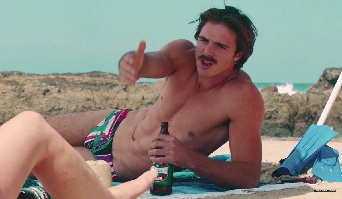 Jacob Elordi in a Speedo drinking beer on the beach