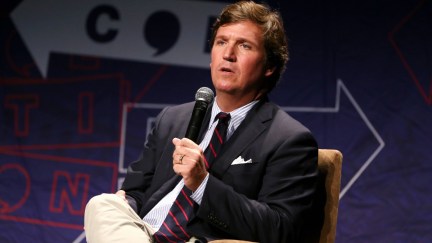 Tucker Carlson looking confused while speaking at Politicon