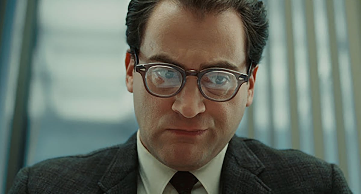 Michael Stuhlbarg looking at a screen wearing glasses in A Serious Man