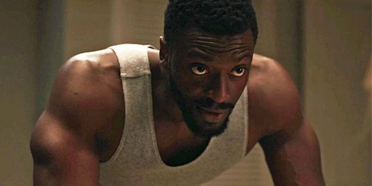 Aldis Hodge leaning over something and looking straight on