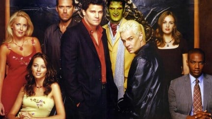 The cast of Angel all posing together with Spike sitting on a desk