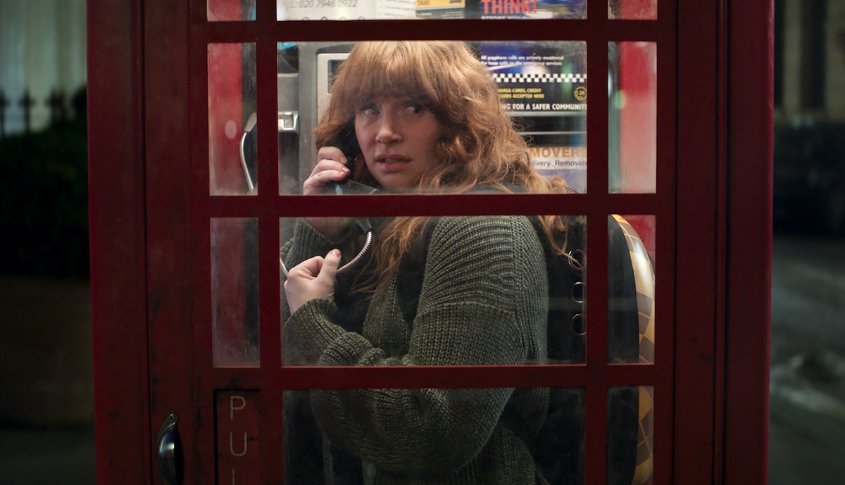 Bryce Dallas Howard on the phone in a phone booth with her cat in Argylle
