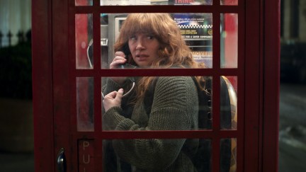 Bryce Dallas Howard on the phone in a phone booth with her cat in Argylle