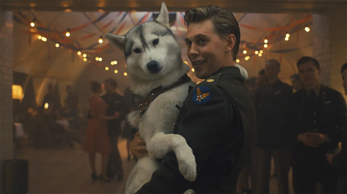 austin butler as buck with a puppy in his arms in masters of air