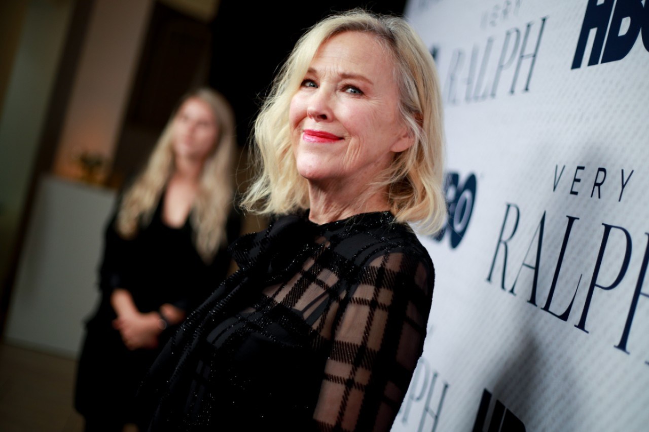 Catherine O'Hara wears a black dress on the red carpet.