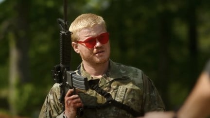 A soldier wears pink sunglasses and holds a machine gun in Civil War.