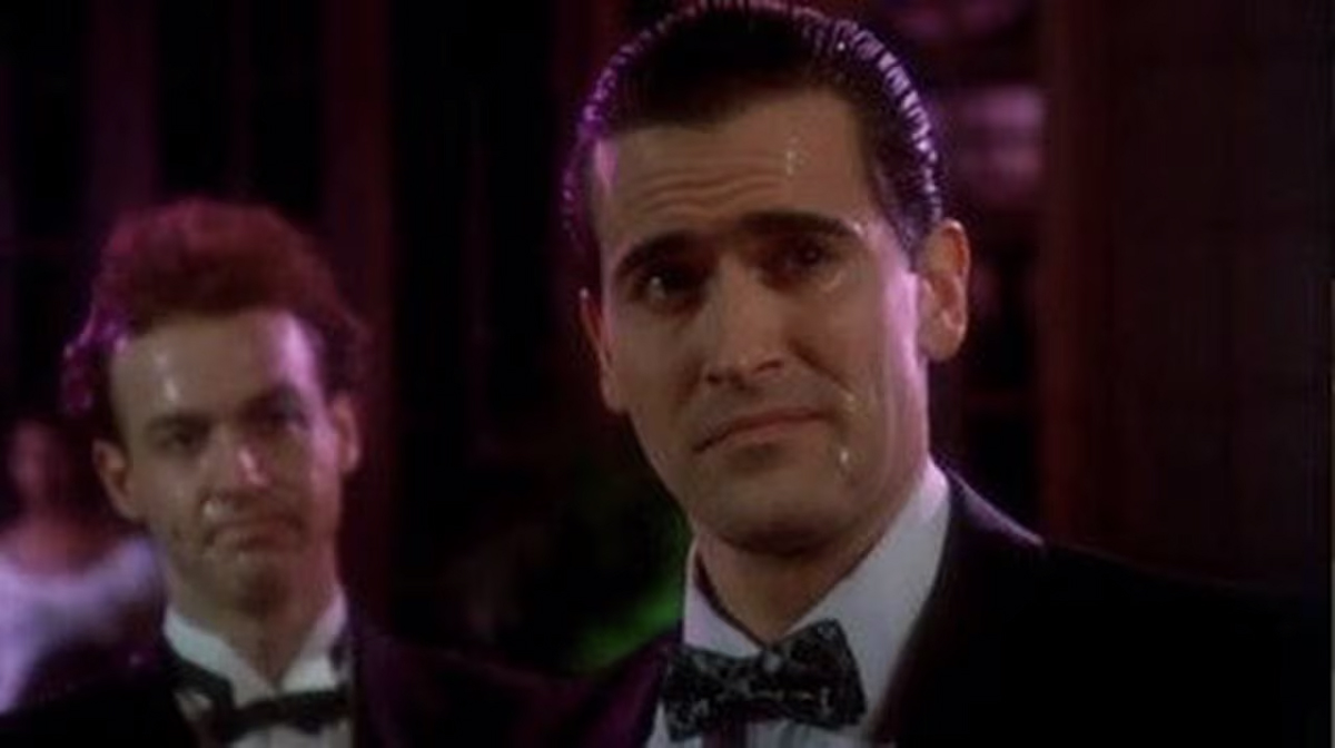 Bruce Campbell looking at the camera in a tux