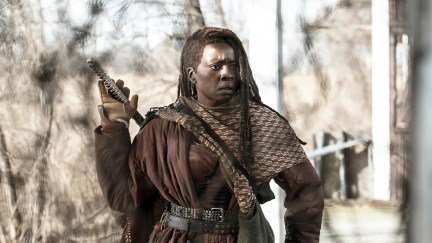 Michonne standing with her hand on a weapon