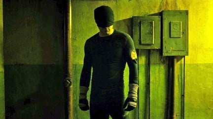 Matt Murdock standing in a hallway listening in his black outfit