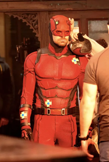 Charlie Cox on the set of Daredevil, wearing his full Daredevil suit and cowl.