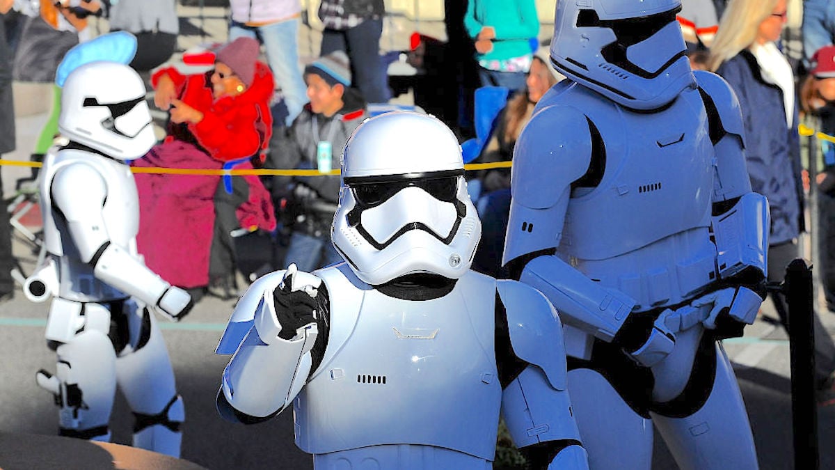 Actors dressed as stormtroopers on a Disney parade float.