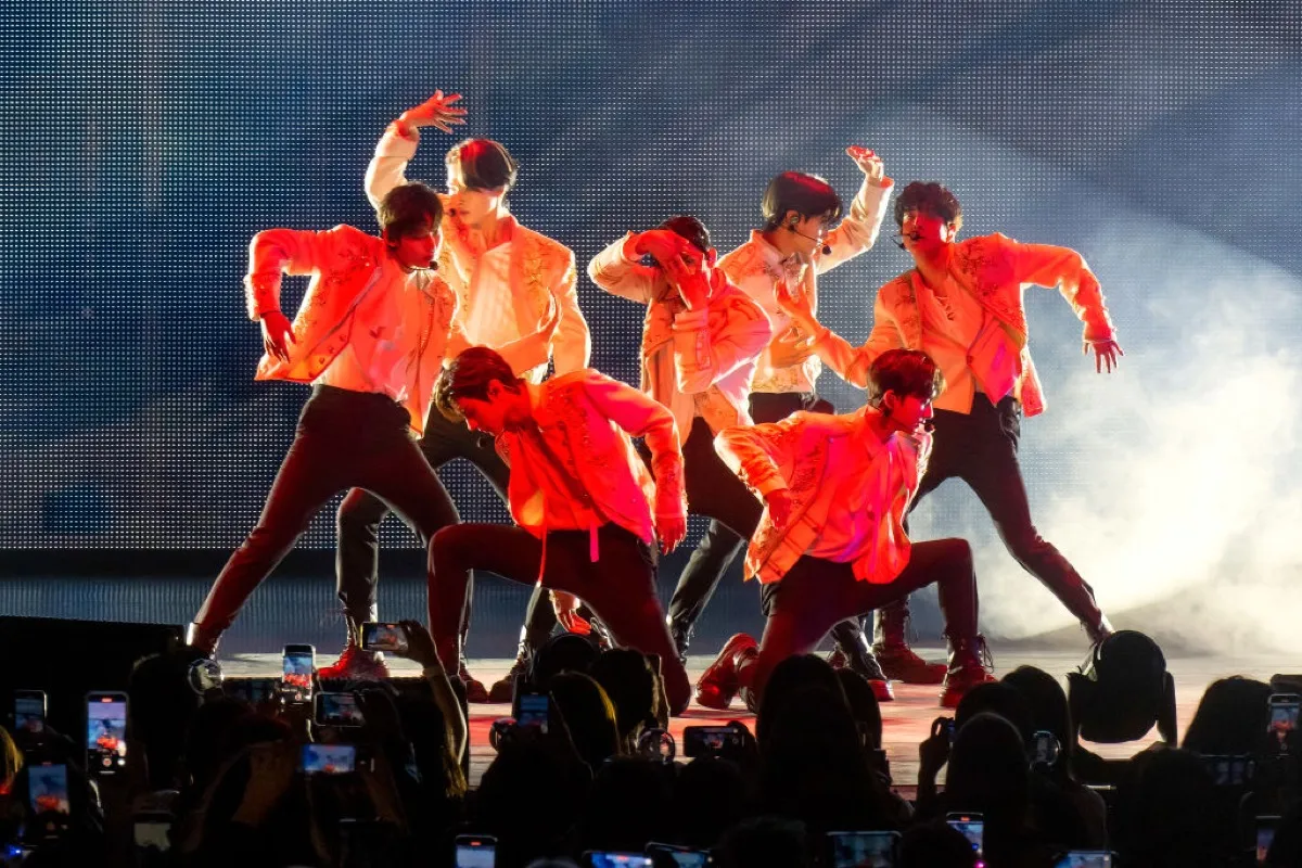 Enhypen (L-R: Sunoo, Ni-ki, Heeseung (center), Jay, Jake / Kneeling left to right: Sunghoon, Jungwon) perform at Radio City Music Hall on October 15, 2022 in New York City.