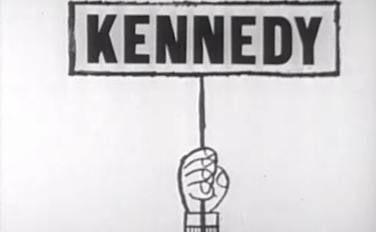 An illustrated hand holds a sign reading "Kennedy"
