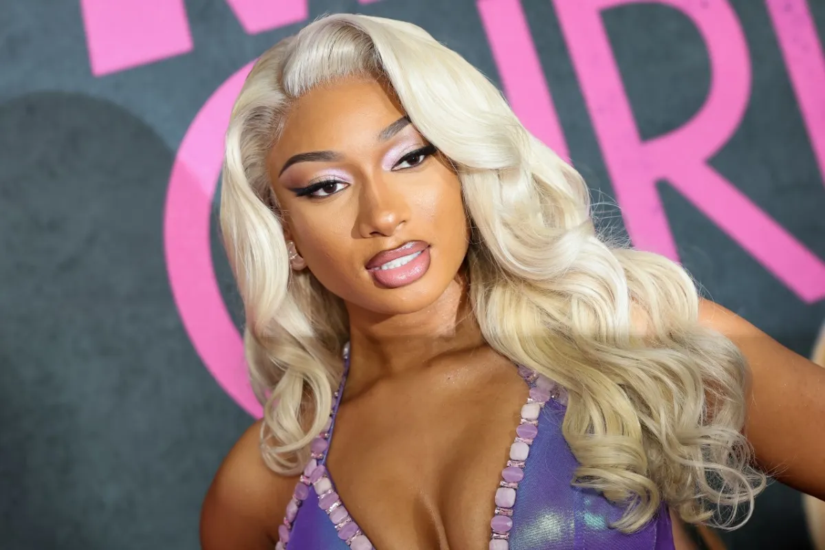 Megan Thee Stallion rocks blonde hair and a purple gown at the 'Mean Girls' premiere.