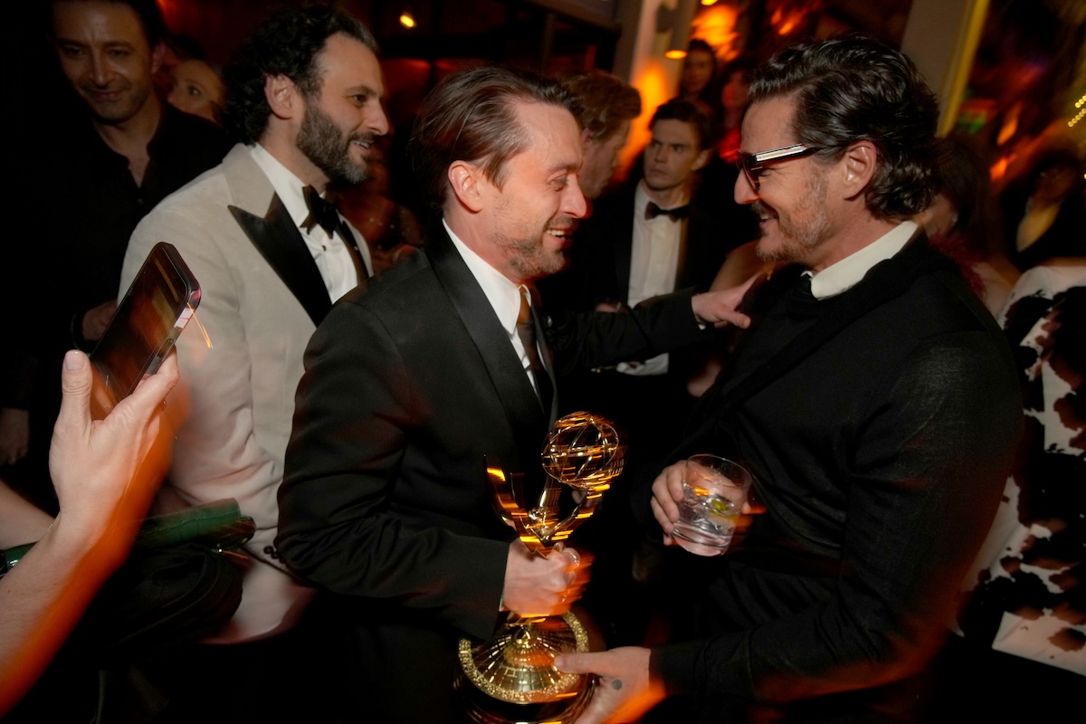 Kieran Culkin and Pedro Pascal smiling at each other 