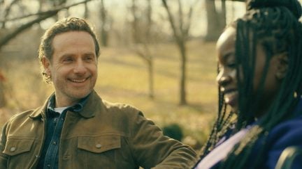 Rick Grimes smiling on a bench with Michonne
