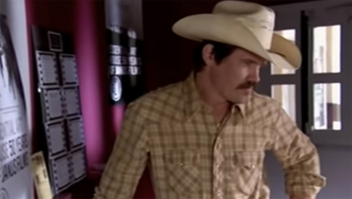 Josh Brolin standing in a cowboy hat
