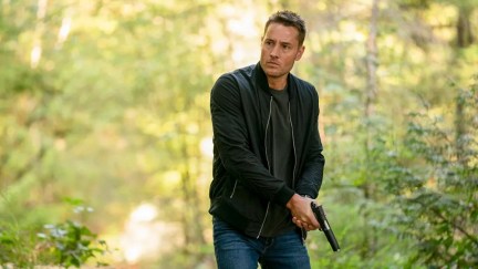 Justin Hartley holds a gun in 'Tracker'.