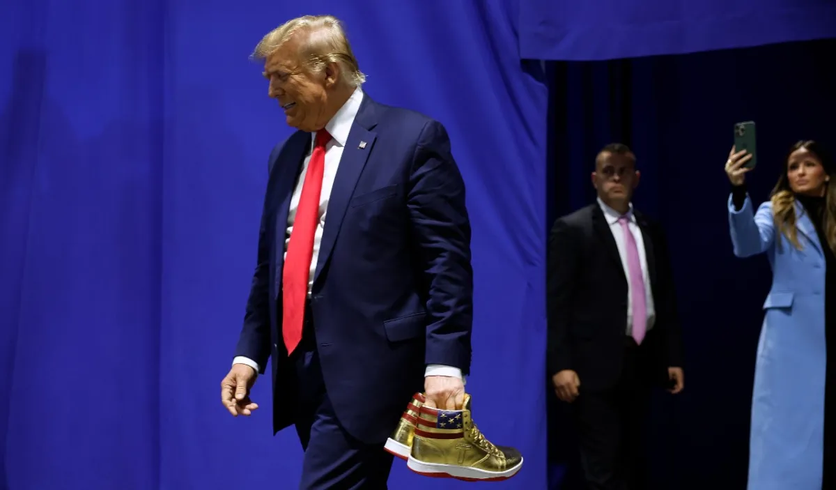 Donald Trump appears at Sneaker Con to sell his gold sneakers.