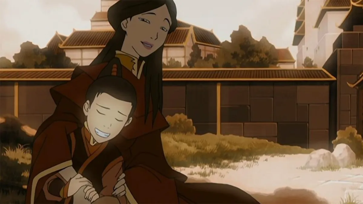 Ursa and her young son Zuko smile sitting together outside.