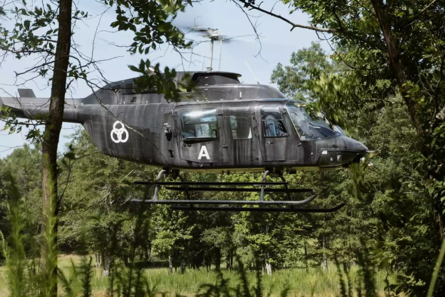 A helicopter with a symbol of three overlapping rings on the side